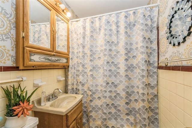 4234 E 68th St, Kansas City, MO 64132 - bathroom with tile walls, wallpapered walls, vanity, and a shower with curtain