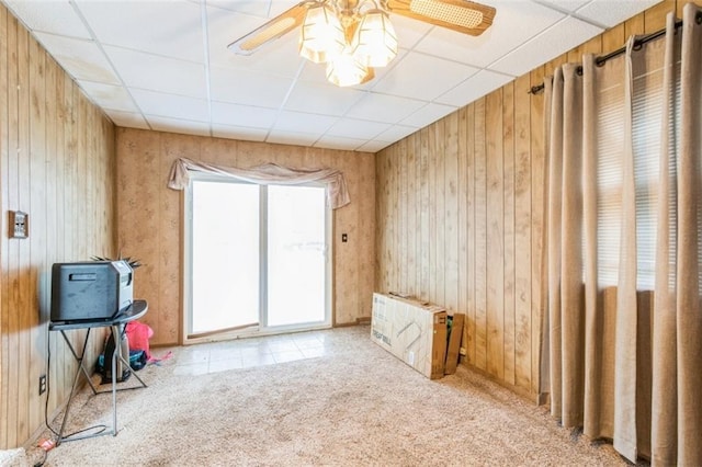 4234 E 68th St, Kansas City, MO 64132 - carpeted empty room featuring wooden walls, ceiling fan, and a paneled ceiling