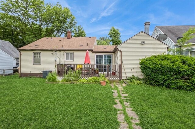 4234 E 68th St, Kansas City, MO 64132 - rear view of property with a lawn, a deck, and a chimney