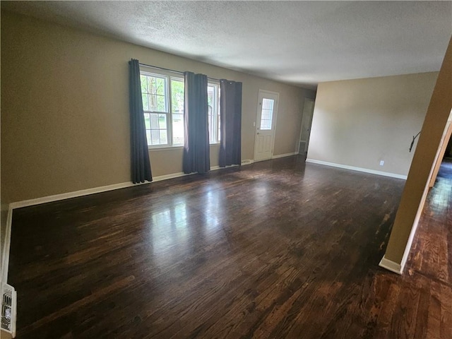 3 N 12th St, Louisburg, KS 66053 - unfurnished room with dark wood-style floors and a textured ceiling