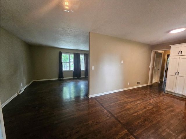 3 N 12th St, Louisburg, KS 66053 - empty room with a textured ceiling and dark wood-type flooring