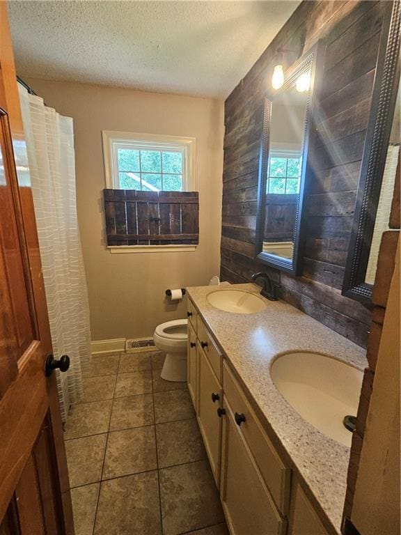 3 N 12th St, Louisburg, KS 66053 - full bath with double vanity, a textured ceiling, and tile patterned flooring