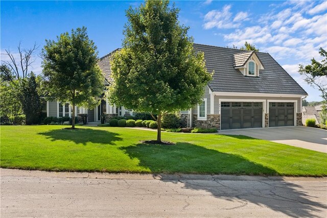 4915 NW Canyon Ct, Lees Summit, MO 64064 - view of front of home featuring driveway, a front yard, stone siding, and an attached garage