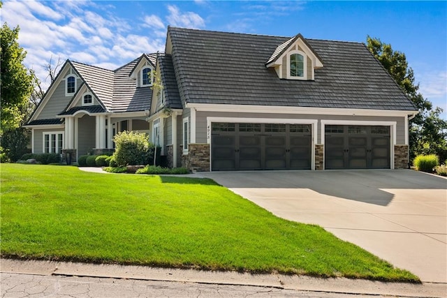4915 NW Canyon Ct, Lees Summit, MO 64064 - view of front of house with driveway, a garage, a front yard, and stone siding
