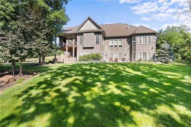 4915 NW Canyon Ct, Lees Summit, MO 64064 - rear view of property with a yard and a balcony