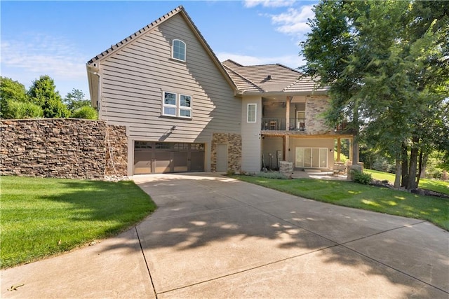 4915 NW Canyon Ct, Lees Summit, MO 64064 - view of front of property with a balcony, concrete driveway, an attached garage, a front yard, and stone siding