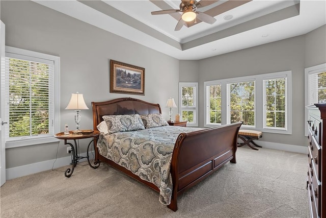 4915 NW Canyon Ct, Lees Summit, MO 64064 - bedroom with light colored carpet, ceiling fan, and a tray ceiling