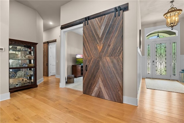 4915 NW Canyon Ct, Lees Summit, MO 64064 - foyer with a barn door, light wood-style floors, a chandelier, and recessed lighting