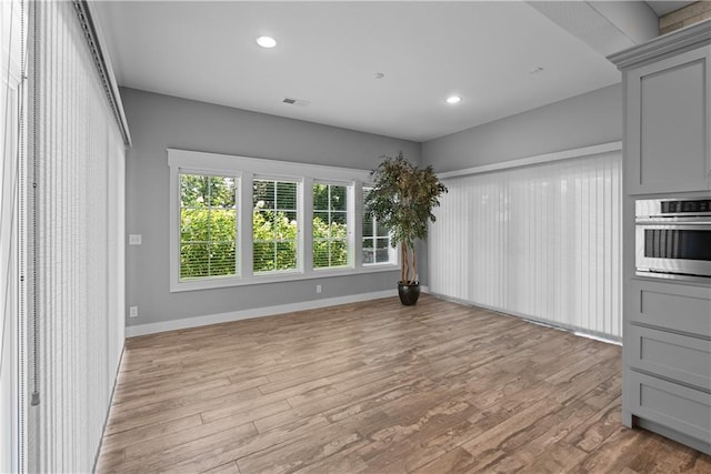 4915 NW Canyon Ct, Lees Summit, MO 64064 - unfurnished dining area featuring light wood-style floors and recessed lighting
