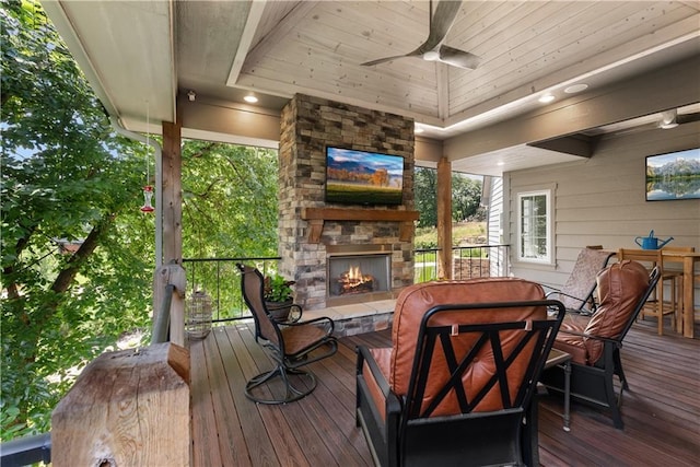 4915 NW Canyon Ct, Lees Summit, MO 64064 - wooden deck with an outdoor stone fireplace, ceiling fan, and outdoor dining area