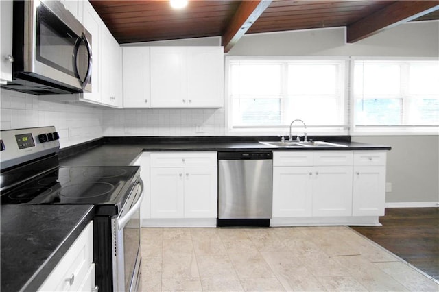 12507 E 46th Ter S, Independence, MO 64055 - kitchen with appliances with stainless steel finishes, a wood ceiling with exposed beams, tasteful backsplash, dark countertops, and white cabinets
