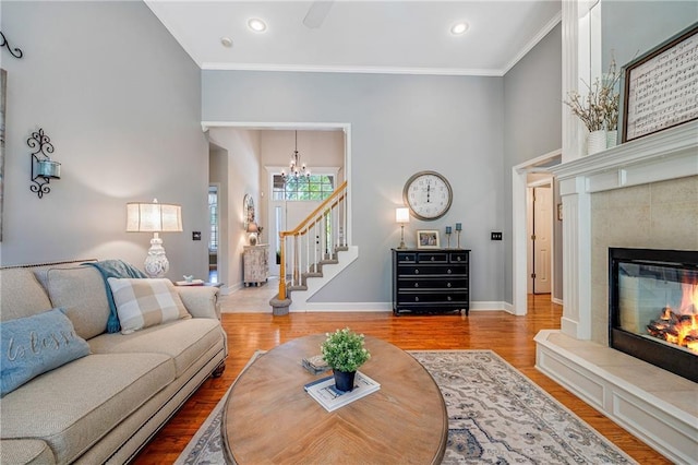 1617 Summit Valley Ln, Lees Summit, MO 64081 - living room with stairs, wood finished floors, crown molding, a fireplace, and a chandelier