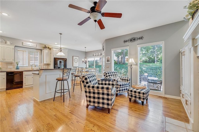 1617 Summit Valley Ln, Lees Summit, MO 64081 - living area with light wood-type flooring, healthy amount of natural light, recessed lighting, a ceiling fan, and a chandelier
