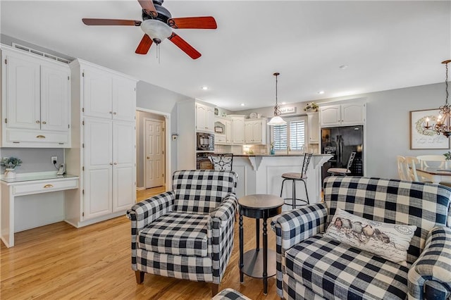 1617 Summit Valley Ln, Lees Summit, MO 64081 - living area featuring light wood-style floors, ceiling fan, a chandelier, and recessed lighting