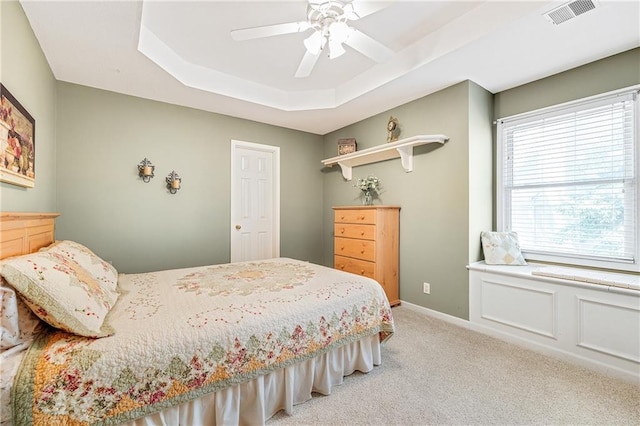 1617 Summit Valley Ln, Lees Summit, MO 64081 - bedroom featuring light colored carpet, a raised ceiling, and a ceiling fan