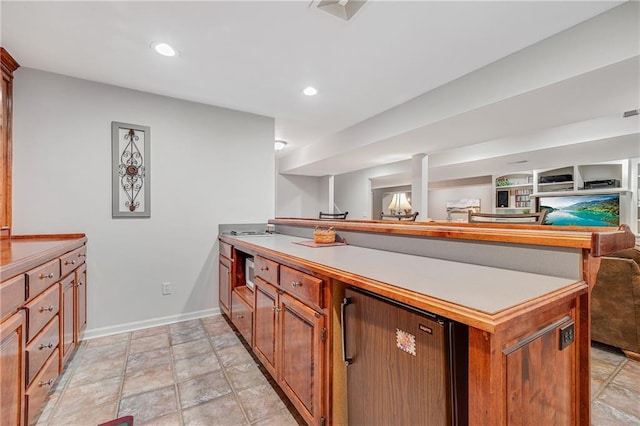 1617 Summit Valley Ln, Lees Summit, MO 64081 - kitchen featuring a peninsula, open floor plan, light stone finish floors, light countertops, and recessed lighting
