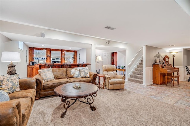 1617 Summit Valley Ln, Lees Summit, MO 64081 - living room featuring bar area, stairs, light colored carpet, and light tile patterned floors