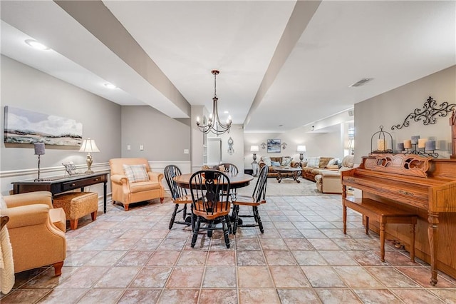 1617 Summit Valley Ln, Lees Summit, MO 64081 - dining space with a chandelier, light stone finish flooring, and wainscoting