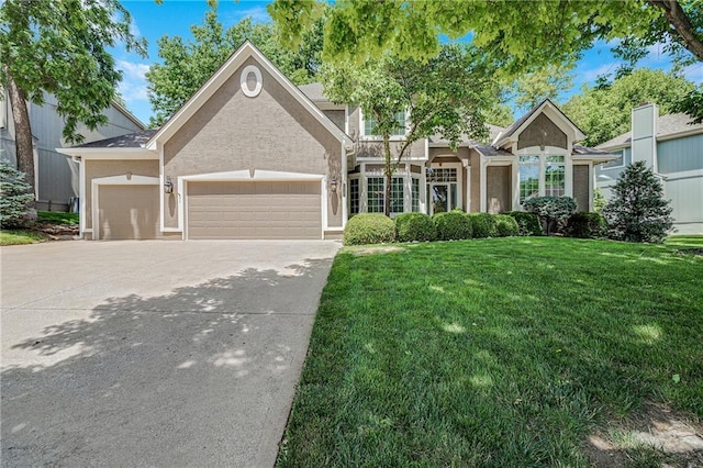 1617 Summit Valley Ln, Lees Summit, MO 64081 - view of front of home featuring an attached garage, a front lawn, concrete driveway, and stucco siding