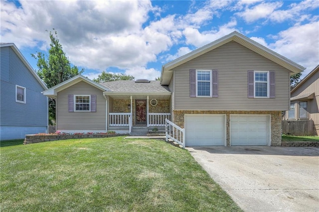 1733 NE Ridgeview Dr, Lees Summit, MO 64086 - split level home with stone siding, covered porch, driveway, a garage, and a front lawn