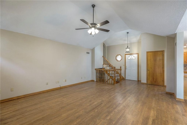 1733 NE Ridgeview Dr, Lees Summit, MO 64086 - unfurnished room with wood finished floors, ceiling fan, vaulted ceiling, and stairs