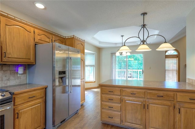 1733 NE Ridgeview Dr, Lees Summit, MO 64086 - kitchen with stainless steel appliances, plenty of natural light, light wood-type flooring, tasteful backsplash, and recessed lighting