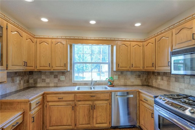 1733 NE Ridgeview Dr, Lees Summit, MO 64086 - kitchen featuring appliances with stainless steel finishes, decorative backsplash, light countertops, and recessed lighting
