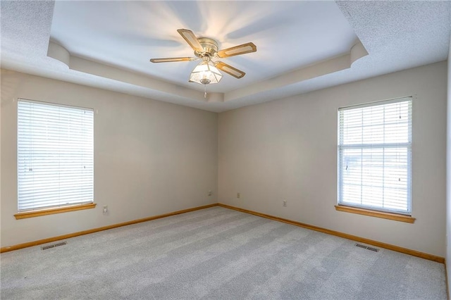 1733 NE Ridgeview Dr, Lees Summit, MO 64086 - empty room with a raised ceiling, light colored carpet, and ceiling fan