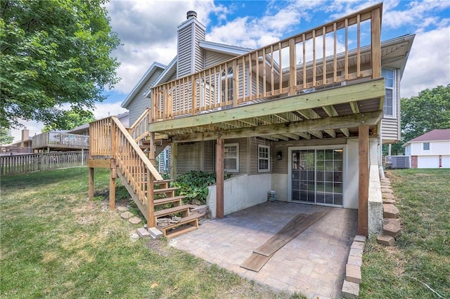 1733 NE Ridgeview Dr, Lees Summit, MO 64086 - back of property with a deck, stairs, a chimney, and a patio area