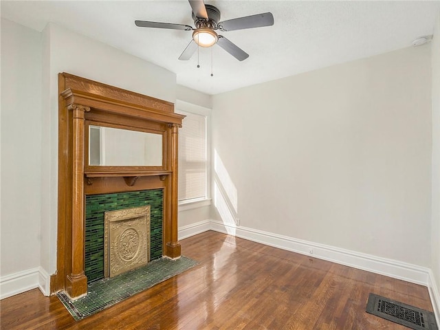 330 Wabash Ave, Kansas City, MO 64124 - unfurnished living room featuring wood finished floors, a fireplace, and a ceiling fan