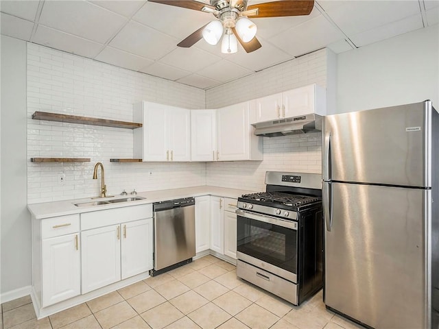 330 Wabash Ave, Kansas City, MO 64124 - kitchen with stainless steel appliances, under cabinet range hood, a paneled ceiling, open shelves, and light countertops