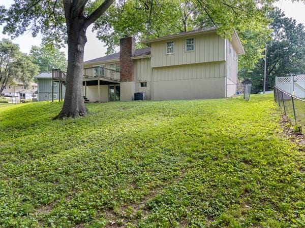 3822 S Trail Ridge Dr, Independence, MO 64055 - back of property with a deck and a chimney