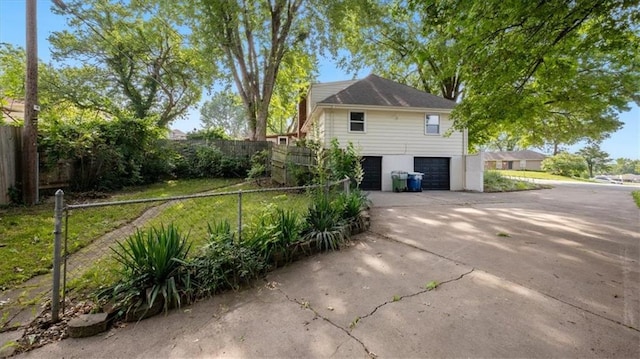 11400 E 62nd Ter, Raytown, MO 64133 - view of side of home featuring a garage and concrete driveway