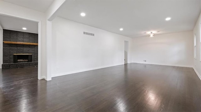 11400 E 62nd Ter, Raytown, MO 64133 - unfurnished living room with a fireplace, dark wood finished floors, and recessed lighting