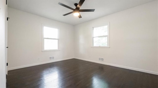 11400 E 62nd Ter, Raytown, MO 64133 - unfurnished room featuring healthy amount of natural light, dark wood-style floors, and ceiling fan