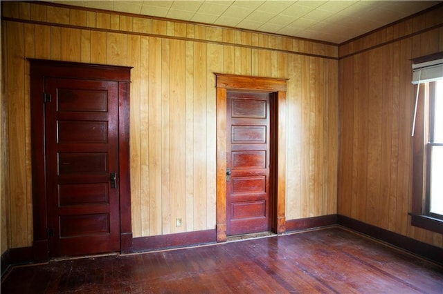 210 S Mulberry St, Paola, KS 66071 - spare room featuring wood finished floors and wood walls