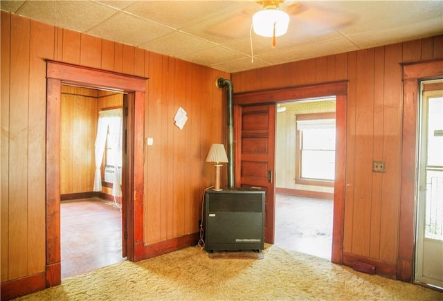 210 S Mulberry St, Paola, KS 66071 - hallway featuring wood walls, carpet, and heating unit