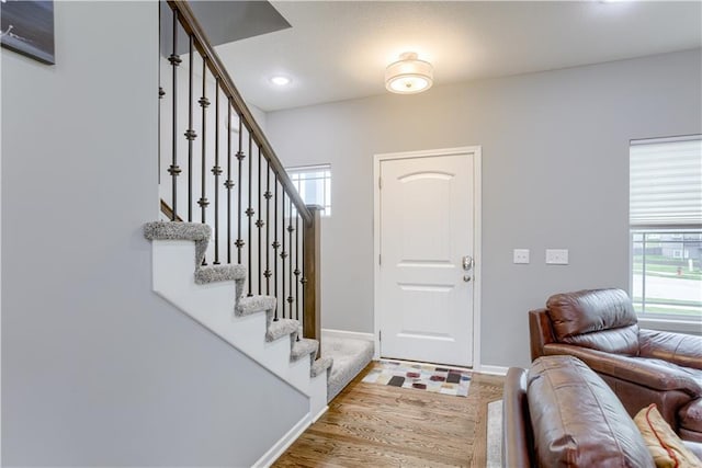 8604 NE 103rd St, Kansas City, MO 64157 - foyer entrance featuring healthy amount of natural light, wood finished floors, stairway, and recessed lighting