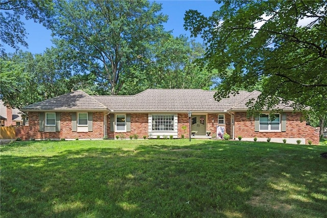 101 W 116th St, Kansas City, MO 64114 - ranch-style home featuring a front yard, brick siding, and a tile roof