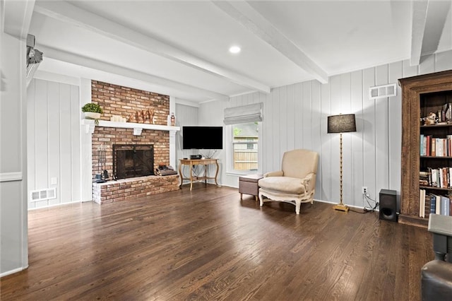 101 W 116th St, Kansas City, MO 64114 - sitting room featuring beam ceiling, wood finished floors, a fireplace, and a decorative wall