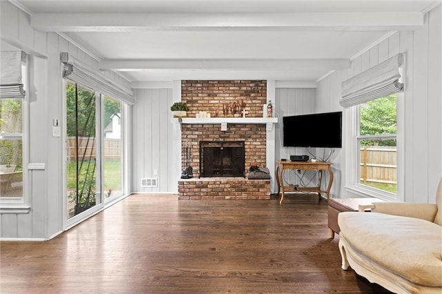 101 W 116th St, Kansas City, MO 64114 - living room featuring beamed ceiling, wood finished floors, a decorative wall, and a brick fireplace