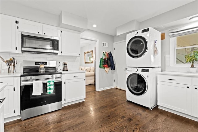 101 W 116th St, Kansas City, MO 64114 - kitchen featuring appliances with stainless steel finishes, stacked washer / dryer, light countertops, recessed lighting, and decorative backsplash