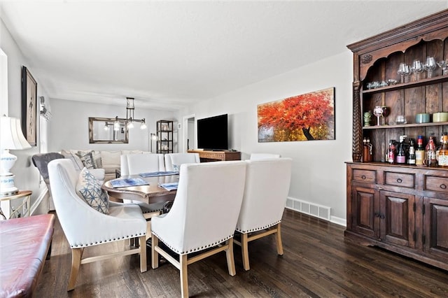 101 W 116th St, Kansas City, MO 64114 - dining area featuring a chandelier and dark wood-style floors