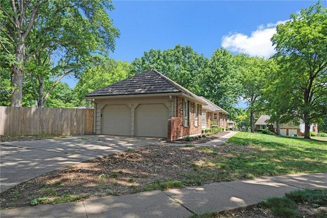 101 W 116th St, Kansas City, MO 64114 - view of side of home featuring brick siding, an attached garage, and concrete driveway