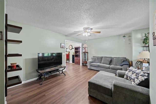 406 Crescent St, Lees Summit, MO 64063 - living area featuring wood finished floors, a ceiling fan, and a textured ceiling