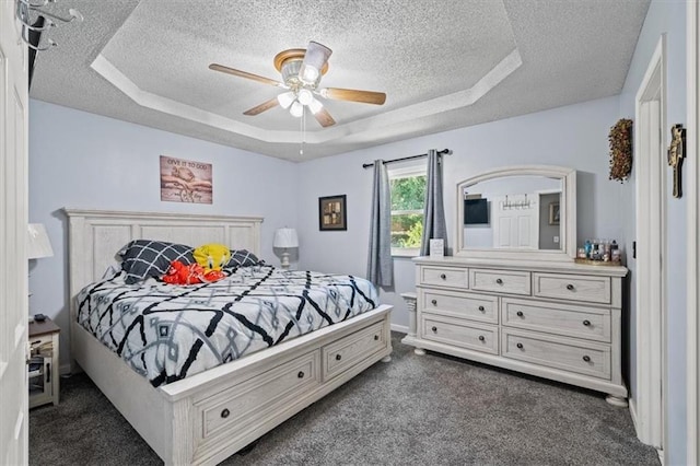 406 Crescent St, Lees Summit, MO 64063 - bedroom with a textured ceiling, dark colored carpet, a tray ceiling, and ceiling fan