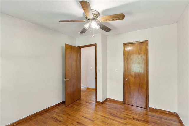 35365 Block Rd, Paola, KS 66071 - unfurnished bedroom with wood finished floors, ceiling fan, and a closet