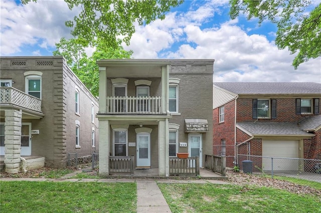 336 N 16th St, Kansas City, KS 66102 - view of property with a garage, a porch, brick siding, and a balcony