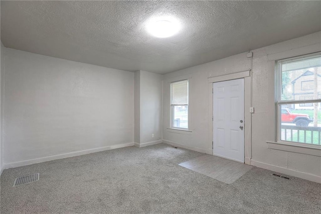 336 N 16th St, Kansas City, KS 66102 - carpeted empty room featuring a textured ceiling and baseboards