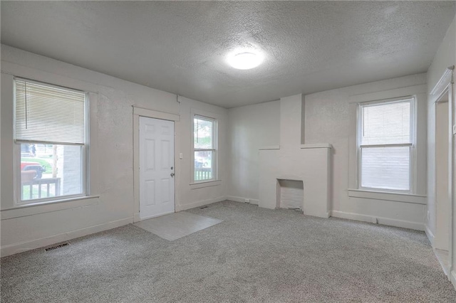 336 N 16th St, Kansas City, KS 66102 - unfurnished living room with a textured ceiling and carpet flooring